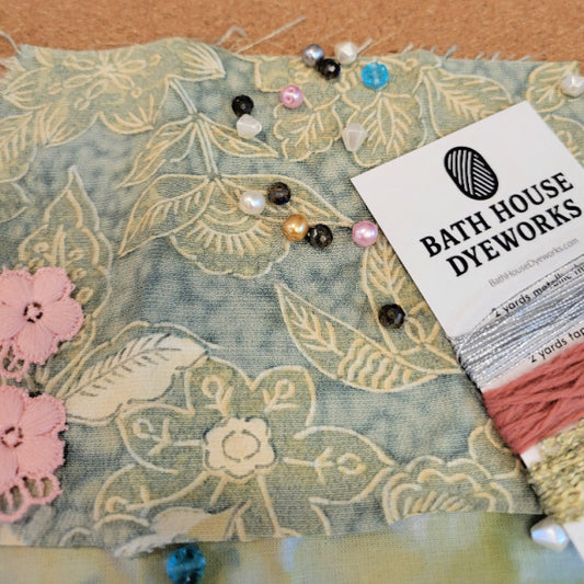 Vintage kimono silk abric with floral patterns and colorful beads on a textured surface, featuring Bath House Dyeworks branding.