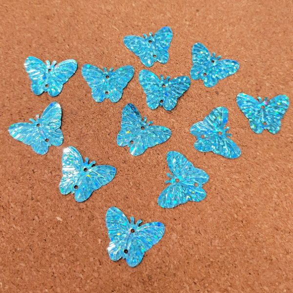 Turquoise blue holographic butterfly sequins with embossed wings and two sewing holes