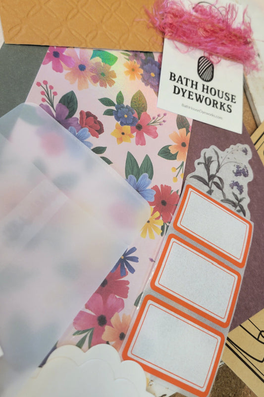 Wildflower ephemera kit with floral paper, translucent envelope, orange labels, botanical sticker and hand-dyed pink eyelash fiber
