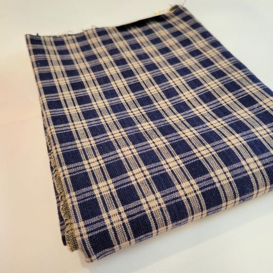Folded vintage navy blue and tan cotton homespun plaid fabric measuring approximately 32 by 46 inches