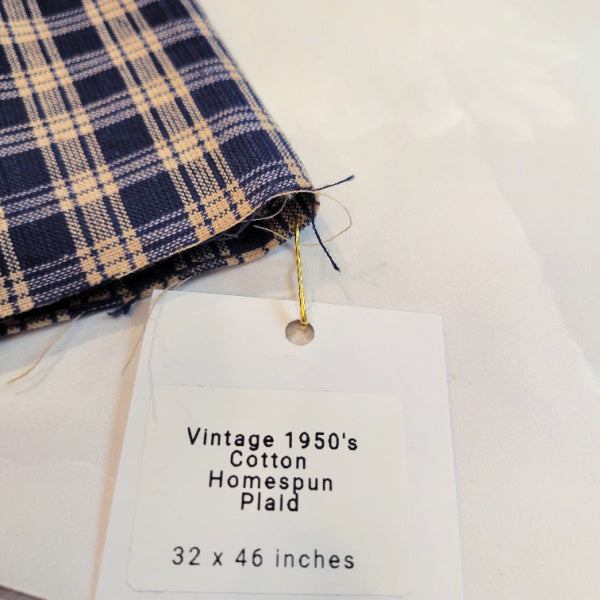 Vintage cotton homespun plaid fabric with attached label identifying the piece as 1950s and 32 by 46 inches