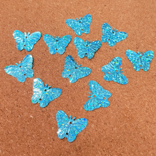 Turquoise blue holographic butterfly sequins with embossed wings and two sewing holes